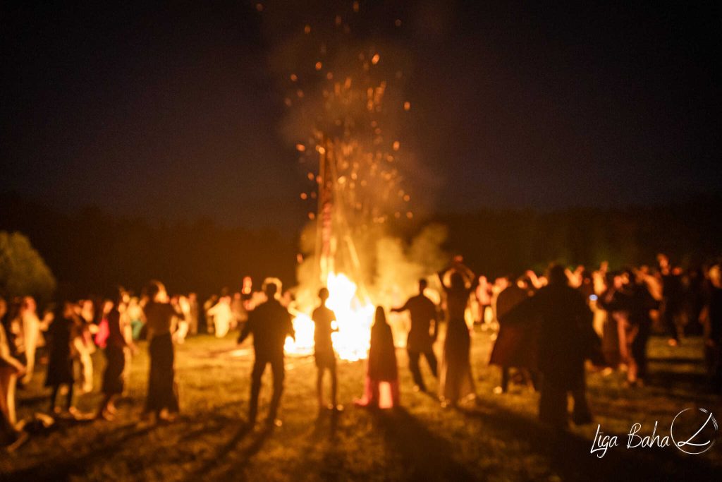 people dancing around fire at solstice night