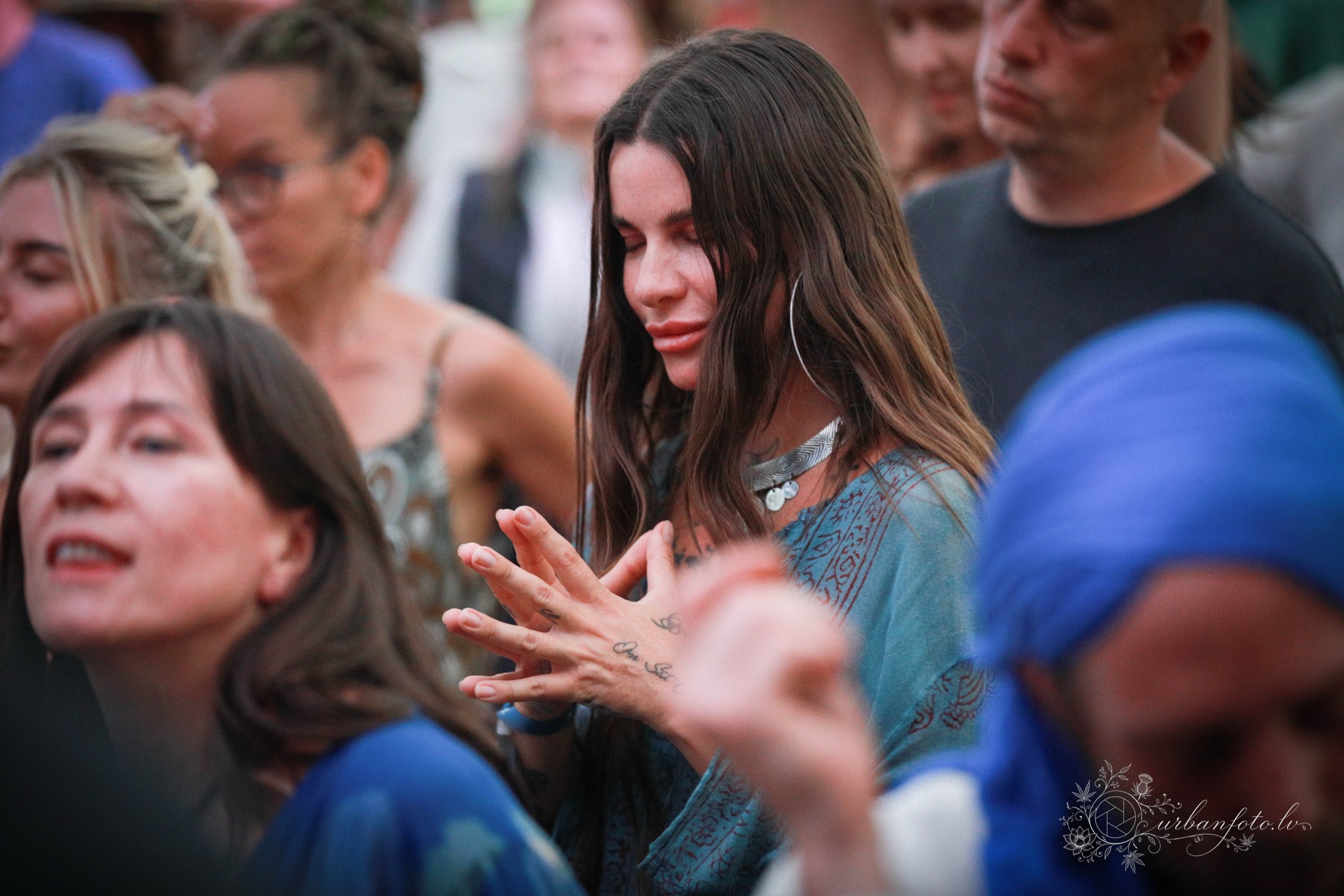 A festival-goer closing her eyes and moving to the rhythm, immersed in the music and mindful dance at BŪTĪBA Festival 2026.