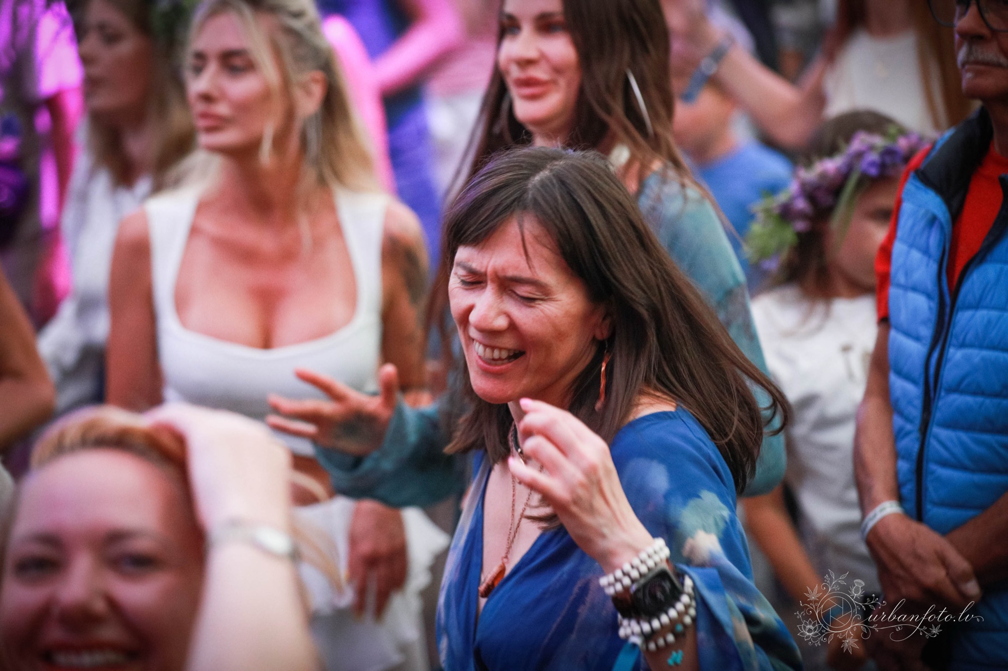 A festival-goer immersed in the music, smiling and dancing joyfully among the crowd at BŪTĪBA Festival 2026.