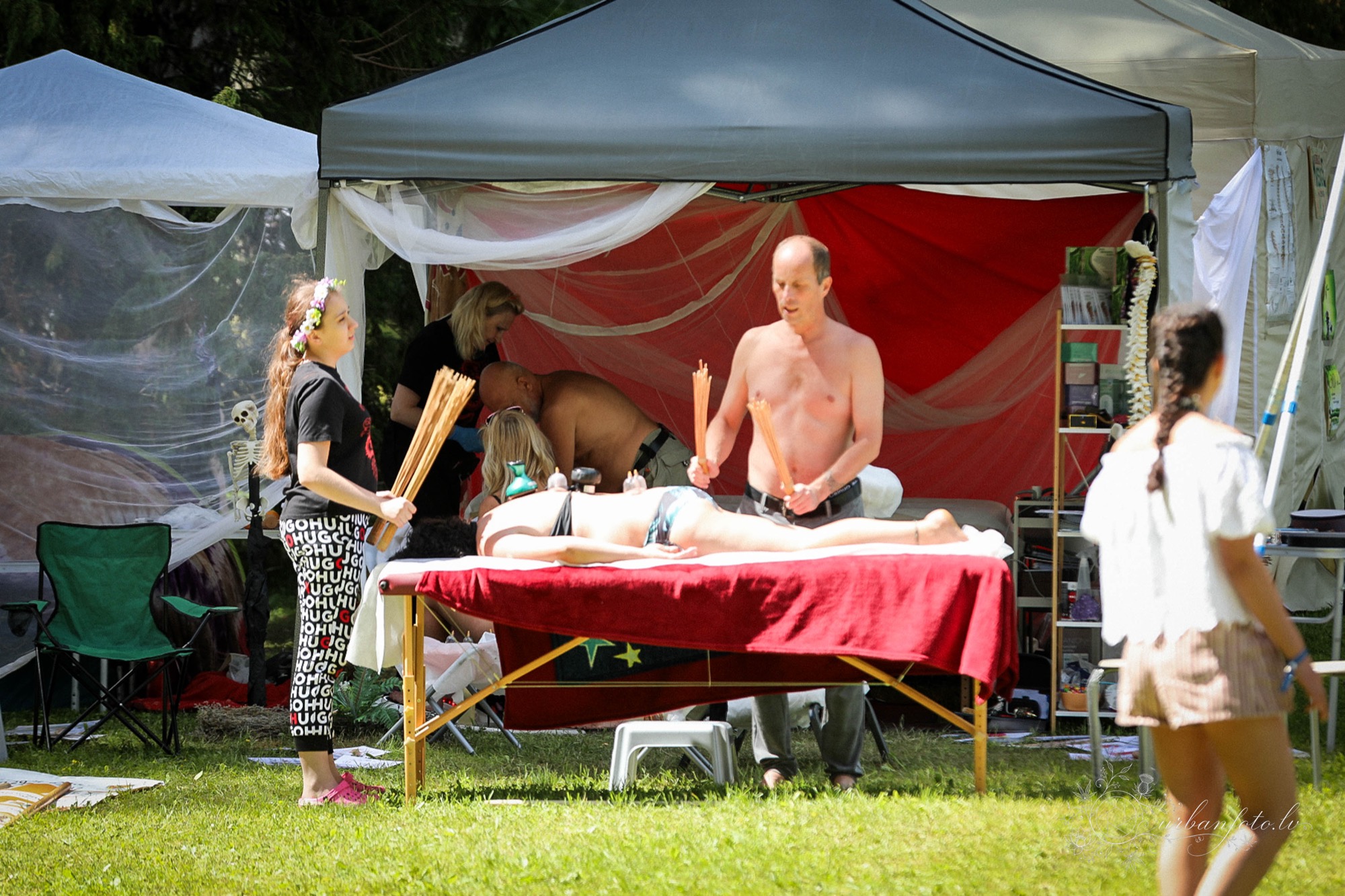 Festival participant receiving a bodywork treatment at a wellness tent during BŪTĪBA Festival 2026