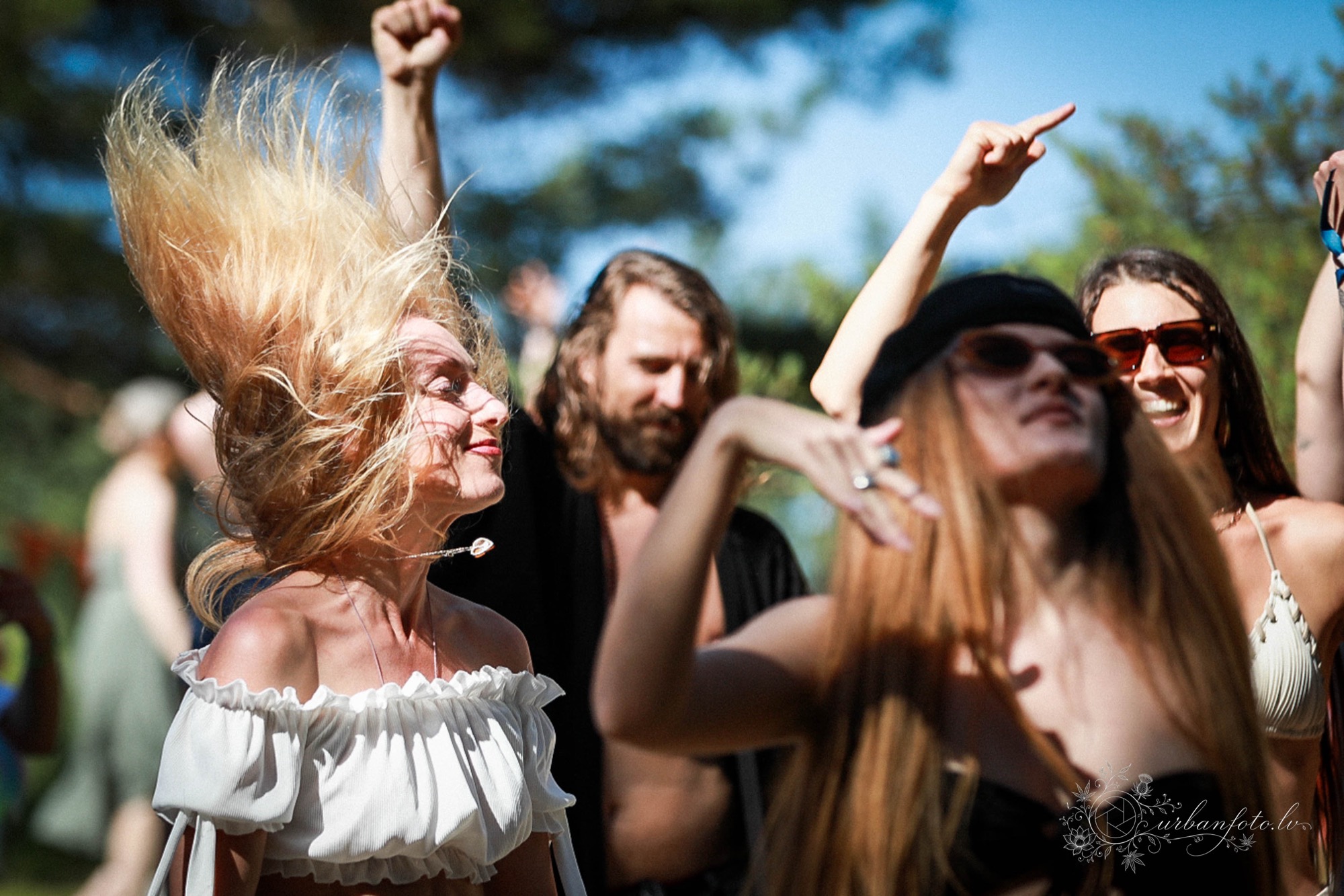Festival-goers dancing wildly and joyfully under the summer sun at BŪTĪBA Festival 2026.