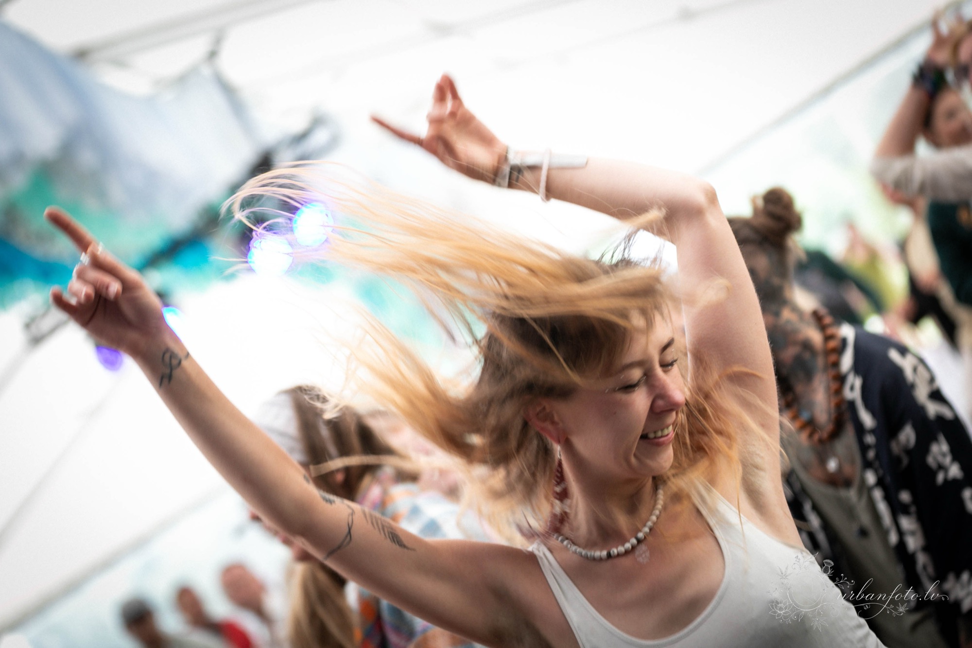 A joyful festival-goer dancing with flying hair and raised arms at BŪTĪBA Festival 2026. 💃✨