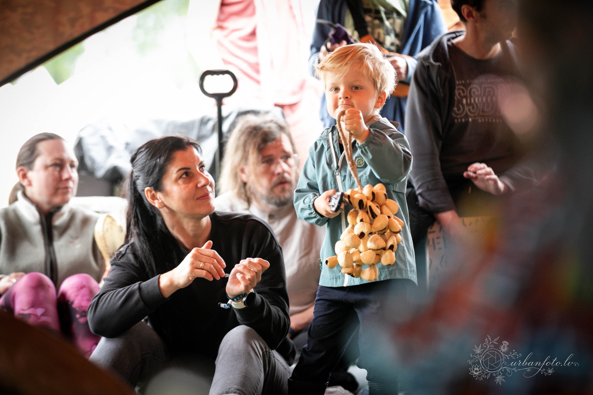Young child playing a wooden percussion instrument during a family music workshop at BŪTĪBA Festival 2026