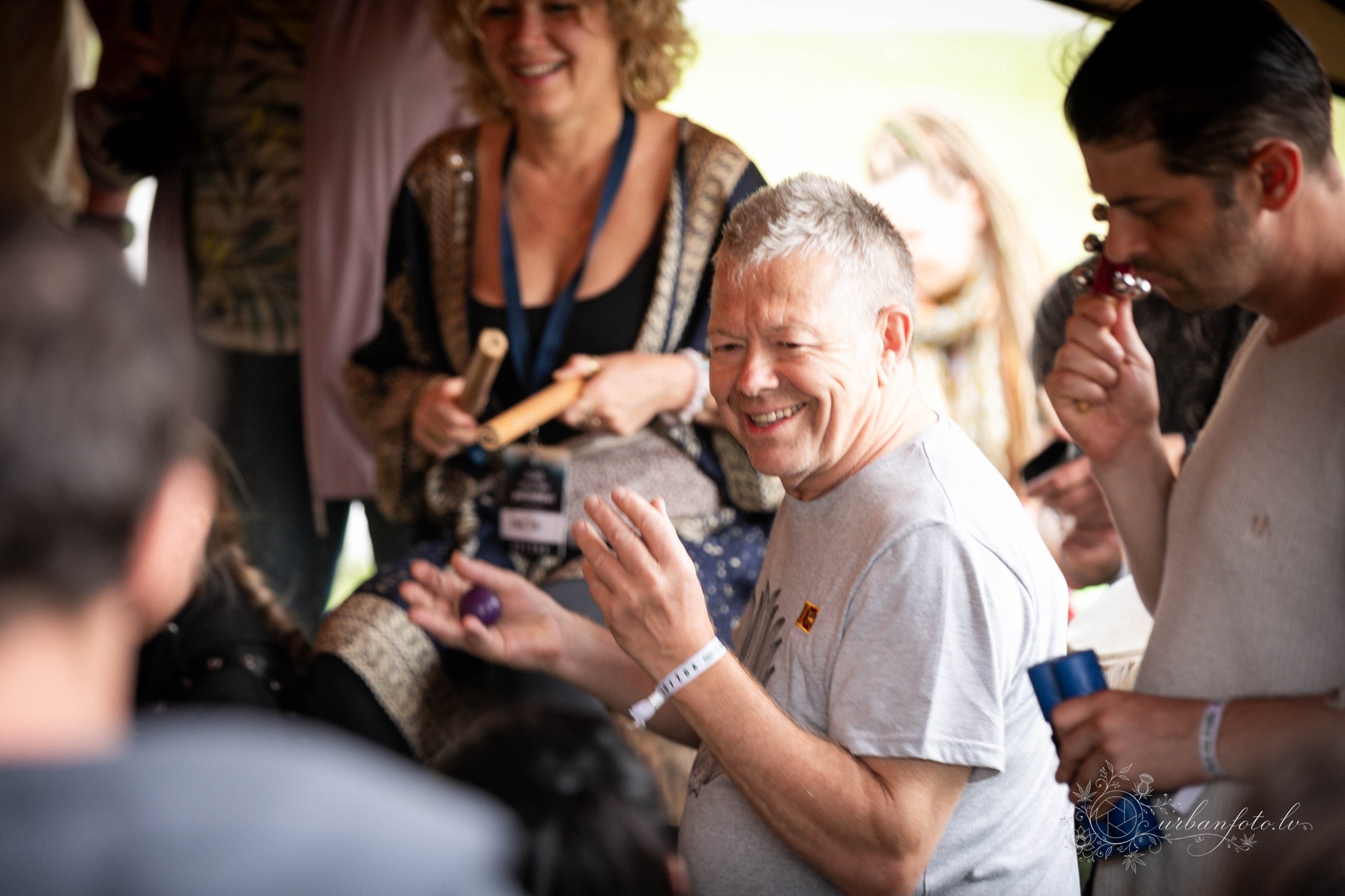 Festival participants playing percussion instruments together during an interactive music workshop at BŪTĪBA Festival 2026