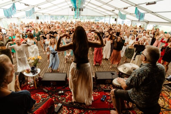 Premal Madina leading a large group of participants in an expressive movement workshop DEVI DANCE at BŪTĪBA Festival 2026