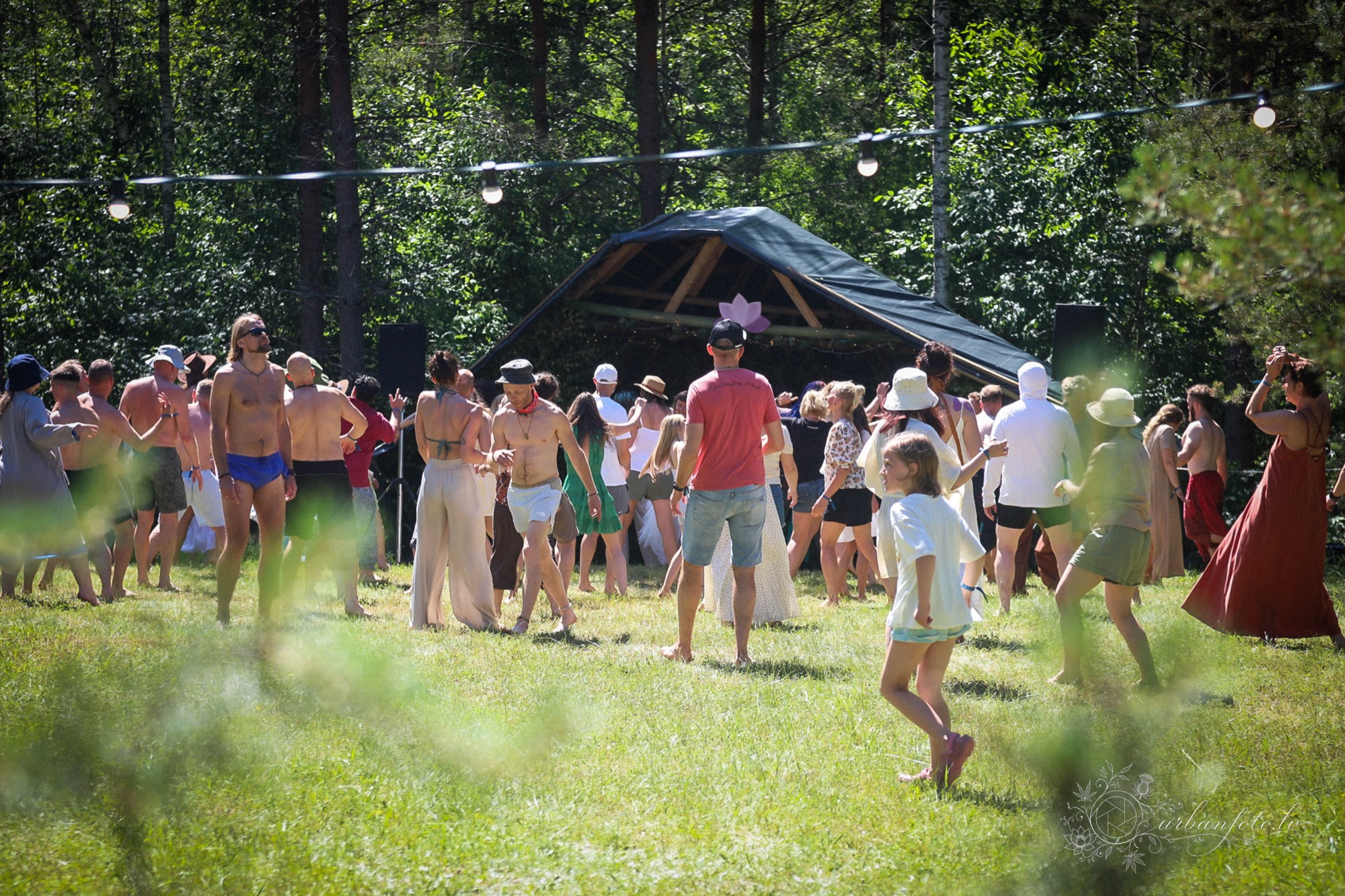 Festival-goers dancing at an outdoor workshop in the forest at BUTIBA Festival
