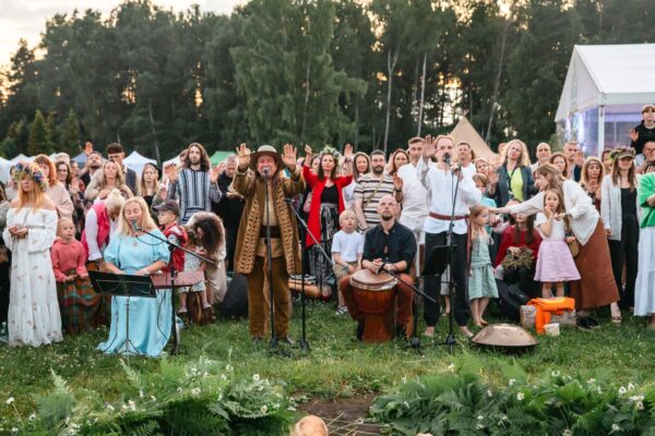 BUTĪBA Festival 2026 community gathered outdoors for a group singing and drumming ceremony with traditional instruments