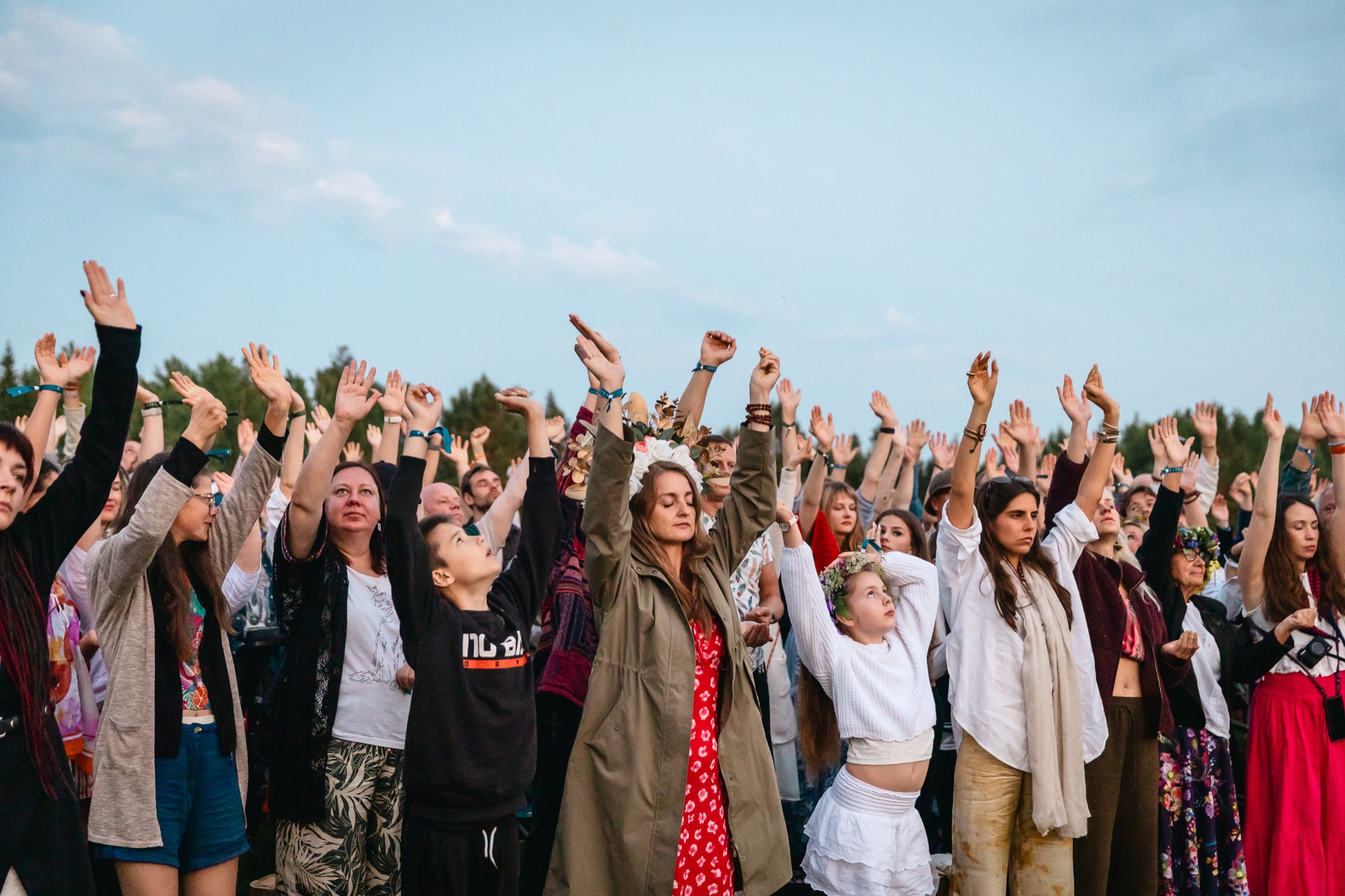 BUTIBA Festival 2026 participants raising their hands together in a joyful outdoor group movement session