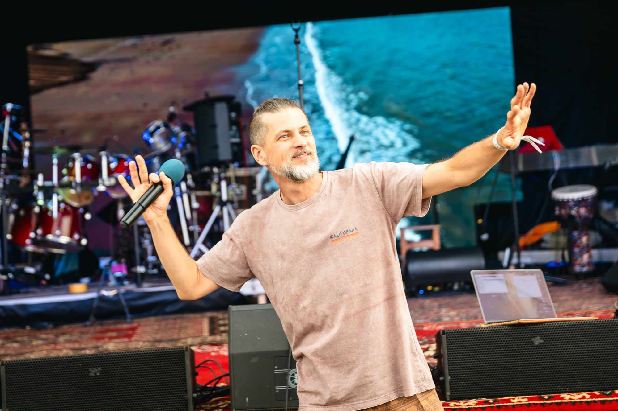 Festival facilitator leading a group activity on stage at BŪTĪBA Festival 2026
