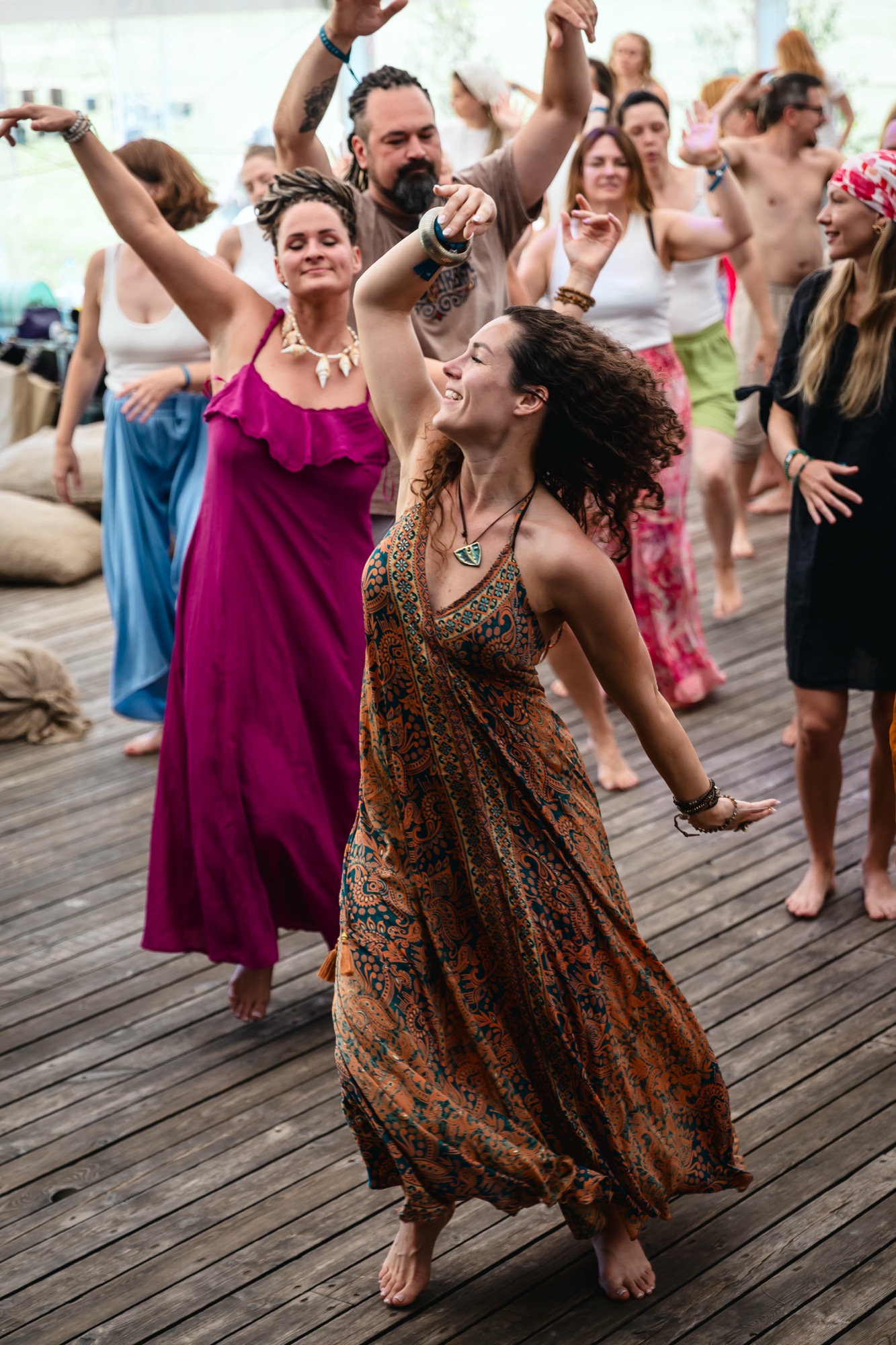 Women dancing freely during a Pulsations workshop at BUTIBA Festival 2026, surrounded by movement, joy and vibrant festival energy.