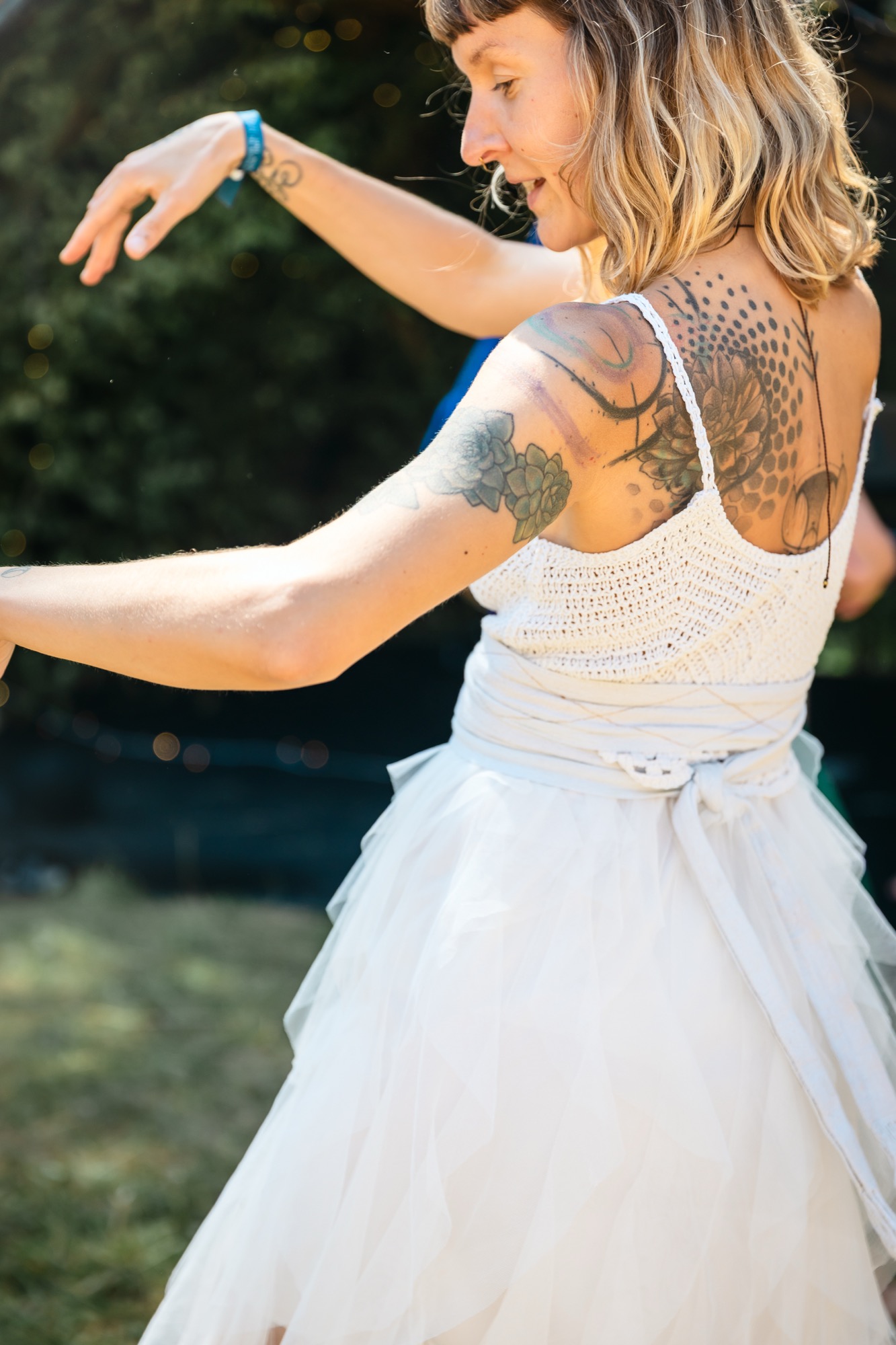 Festival-goer dancing freely in a white dress, embodying the joyful energy and vibrant atmosphere of BUTIBA Festival 2026.