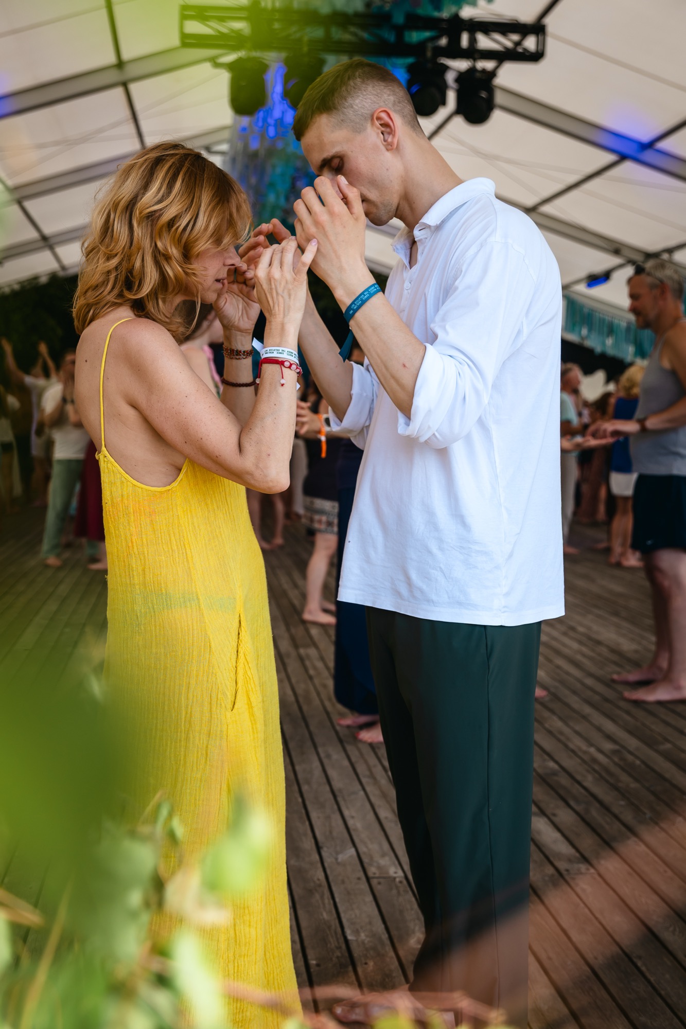 Two participants practicing a mindful partner connection exercise during a BŪTĪBA Festival 2026 workshop