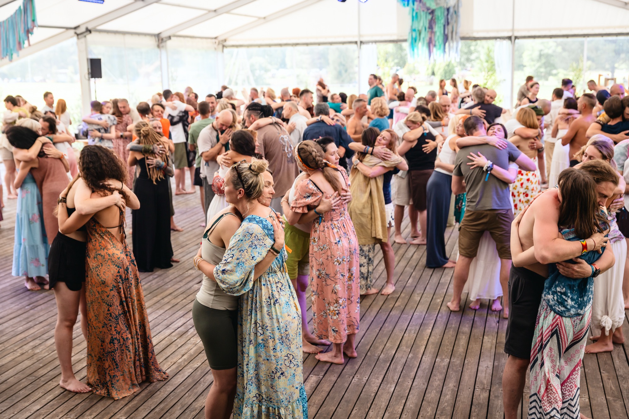 Festival participants embracing one another during a group connection and movement workshop at BŪTĪBA Festival 2026