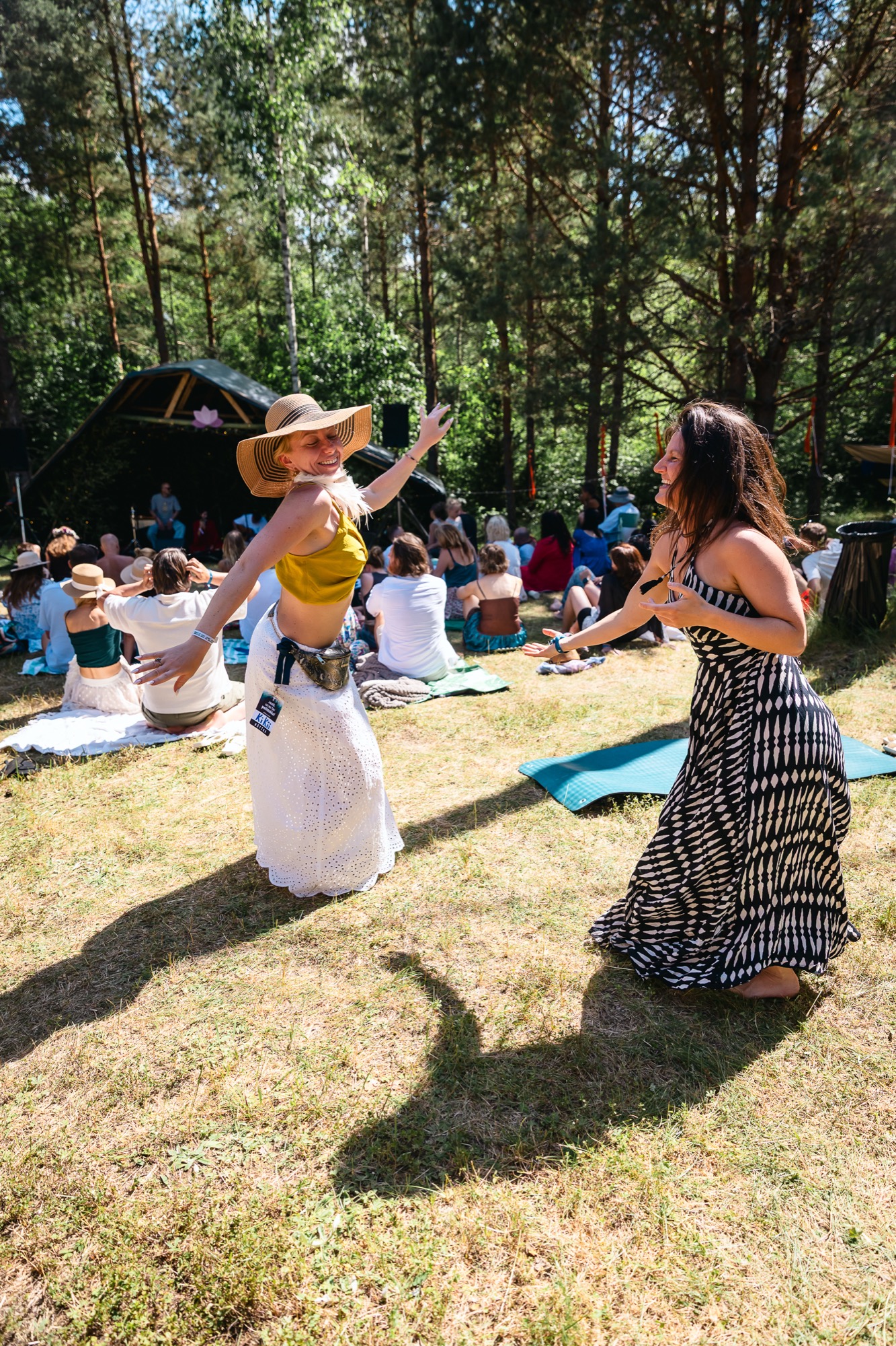 Festival-goers dancing in the sunshine, surrounded by nature and the vibrant energy of BUTIBA 2026.