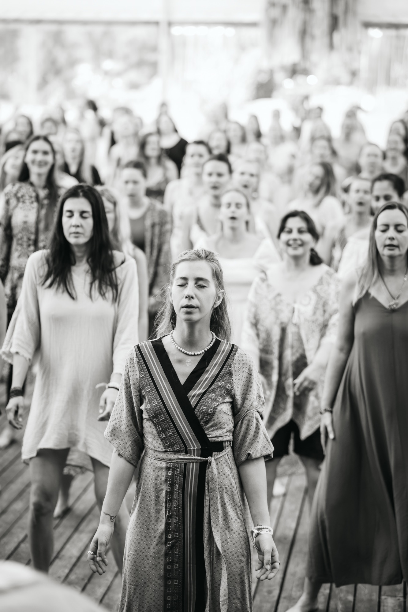 Women participating in a guided meditation or mindfulness workshop with Premal Madina at BŪTĪBA Festival 2026, with eyes closed in a quiet moment of reflection