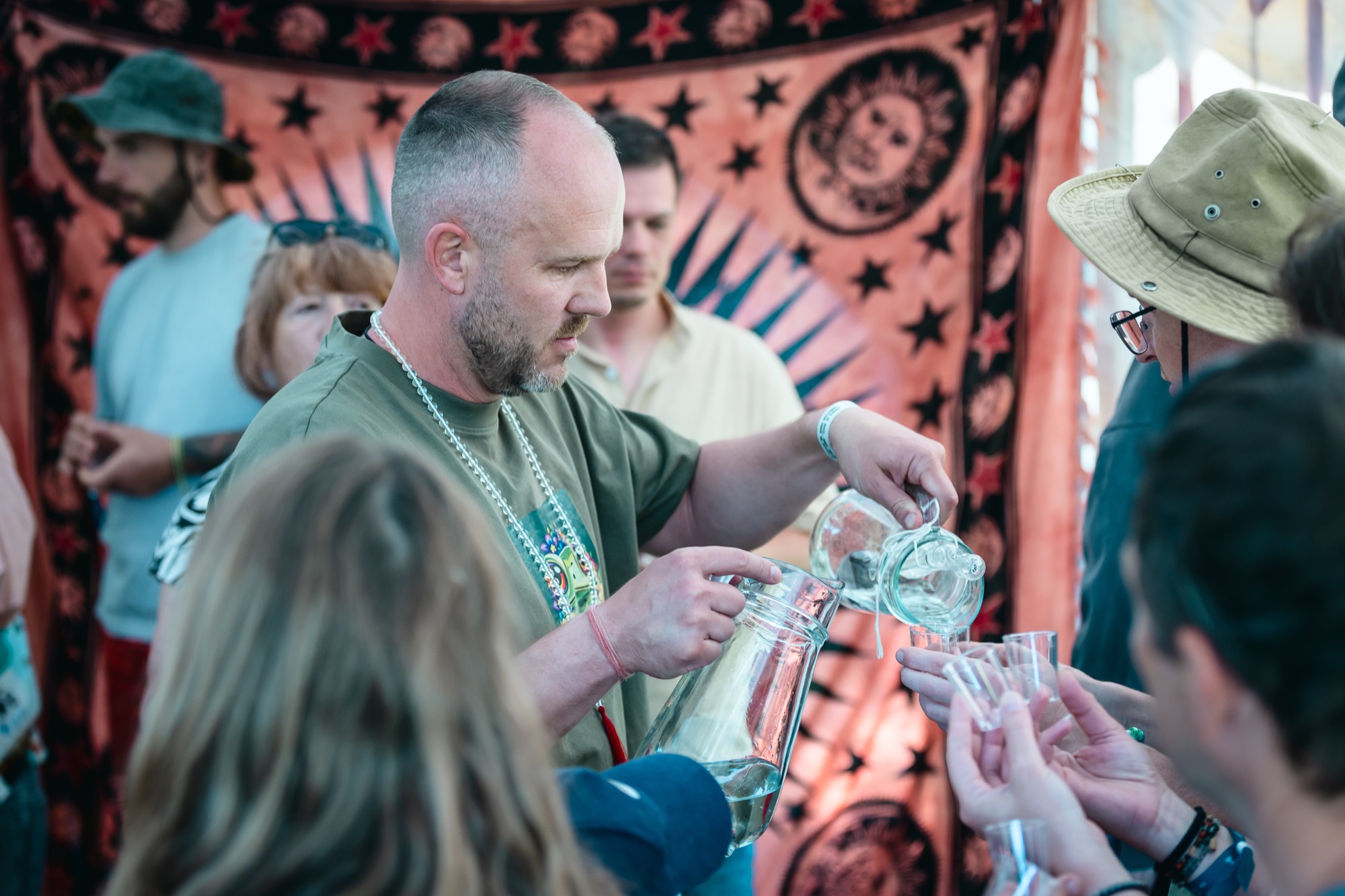 Water essence masterclass at BŪTĪBA Festival 2026, with participants gathered around a table during a hands-on demonstration