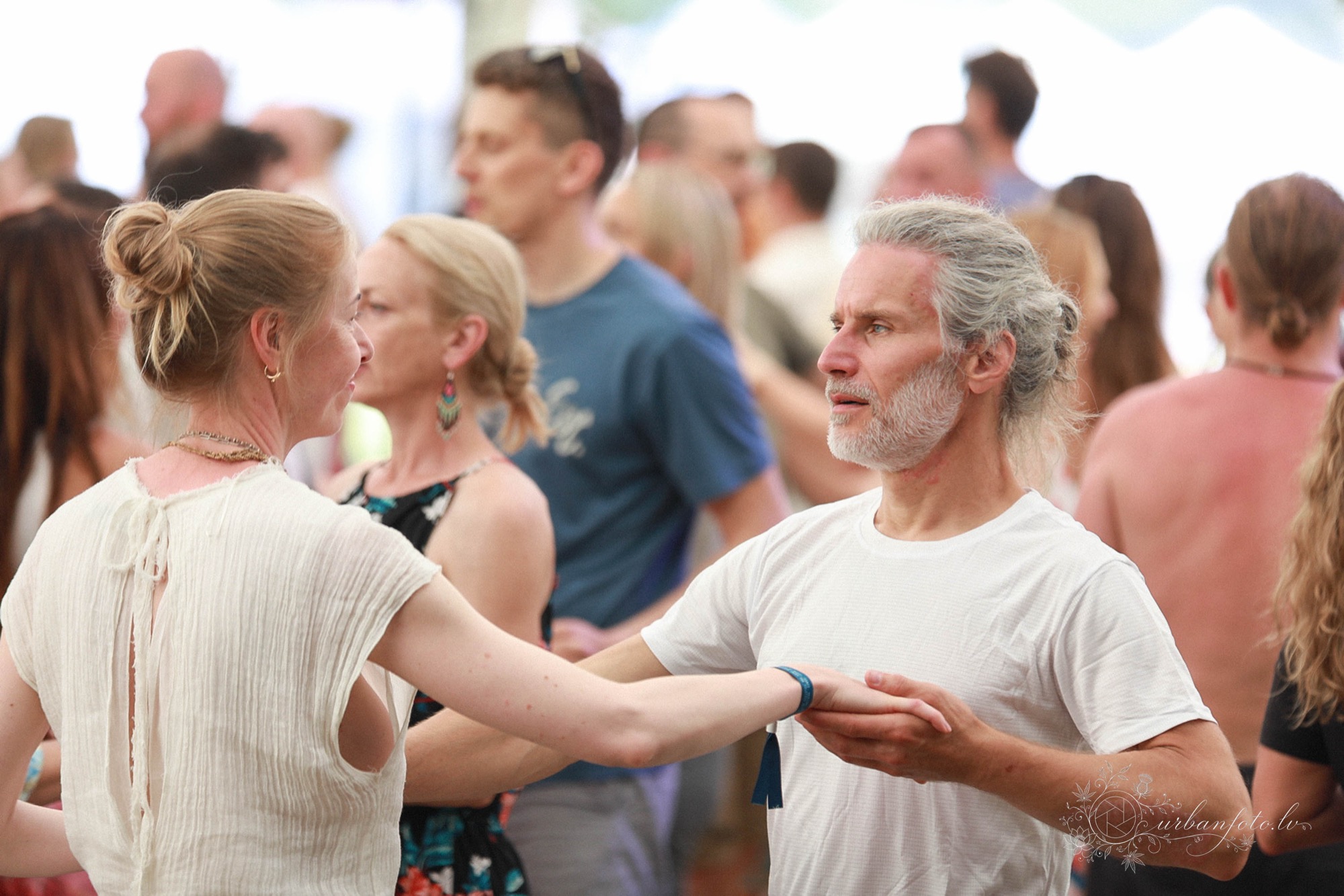 Participants connecting through partner movement during a Pulsations session at BŪTĪBA Festival 2026