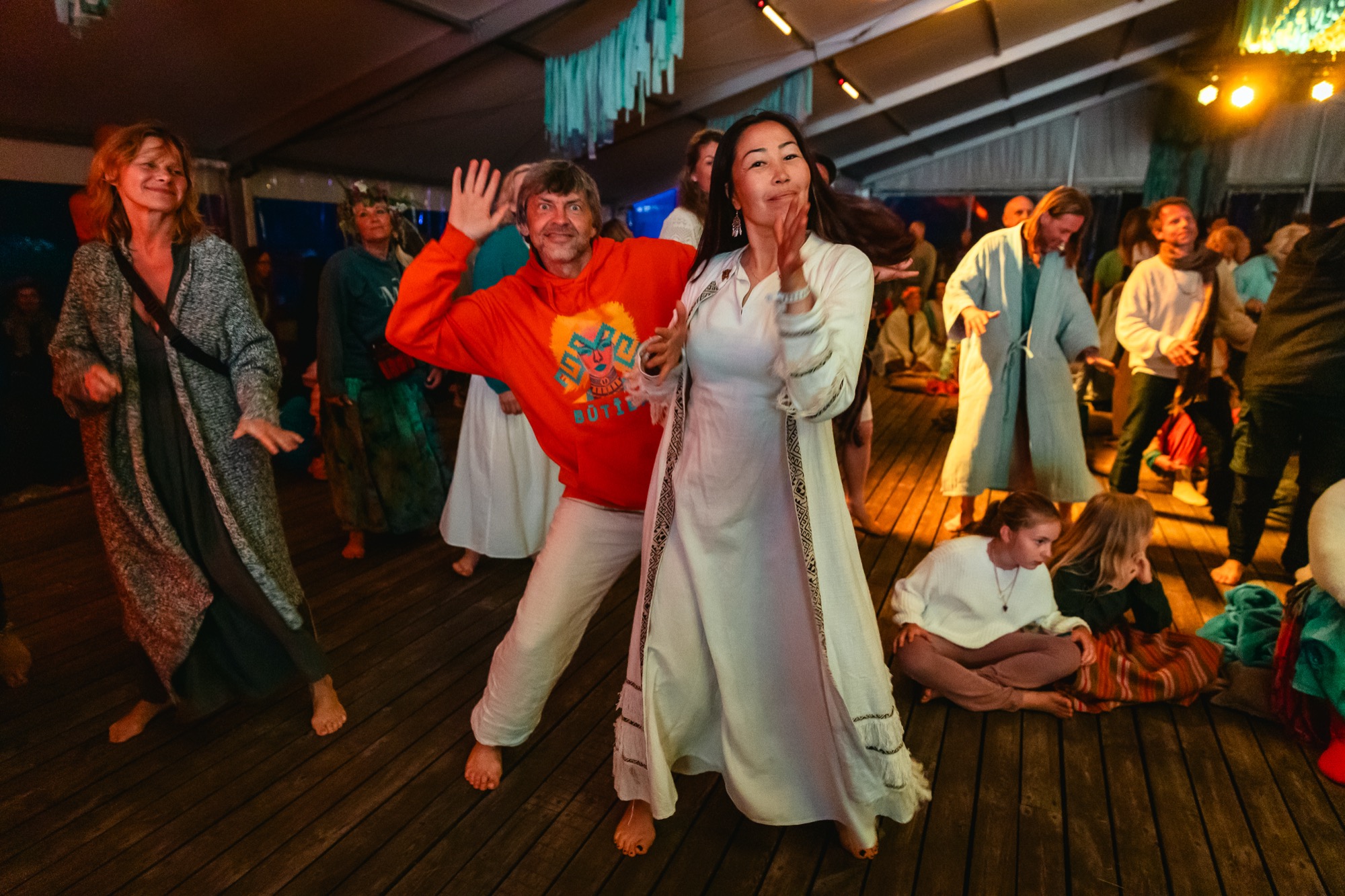 Festival participants dancing together during an evening music and dance session at BŪTĪBA Festival 2026