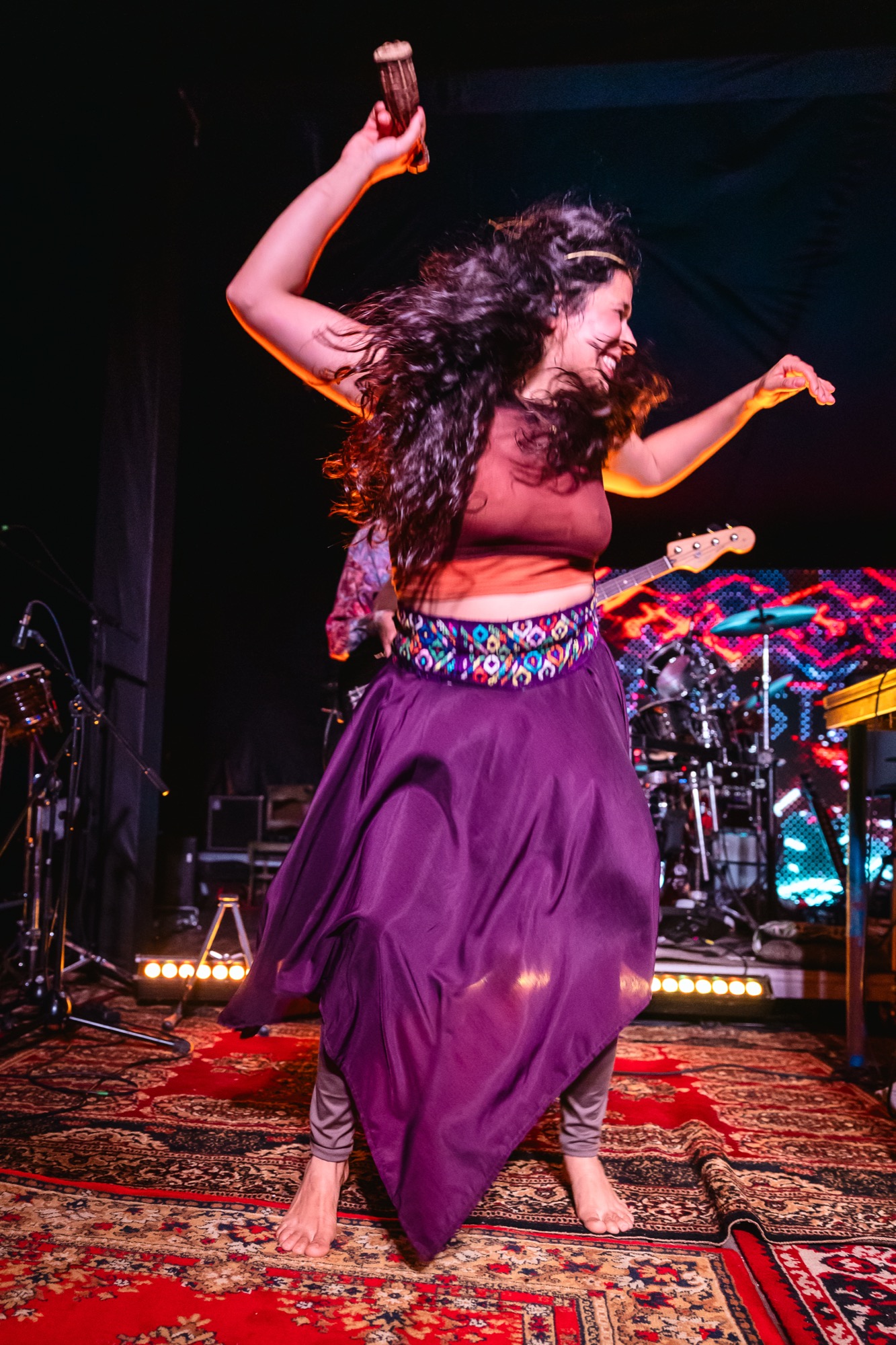 La Forasteria vocalist dancing barefoot on stage during a live performance at BŪTĪBA Festival 2026