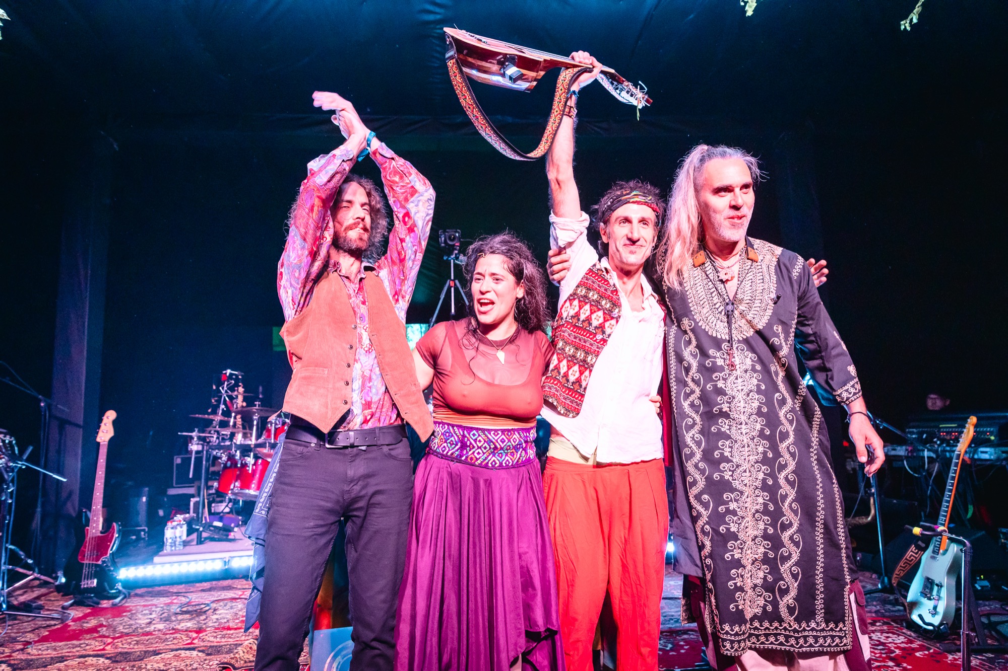 La Forasteria band members celebrating together on stage after a live performance at BŪTĪBA Festival 2026