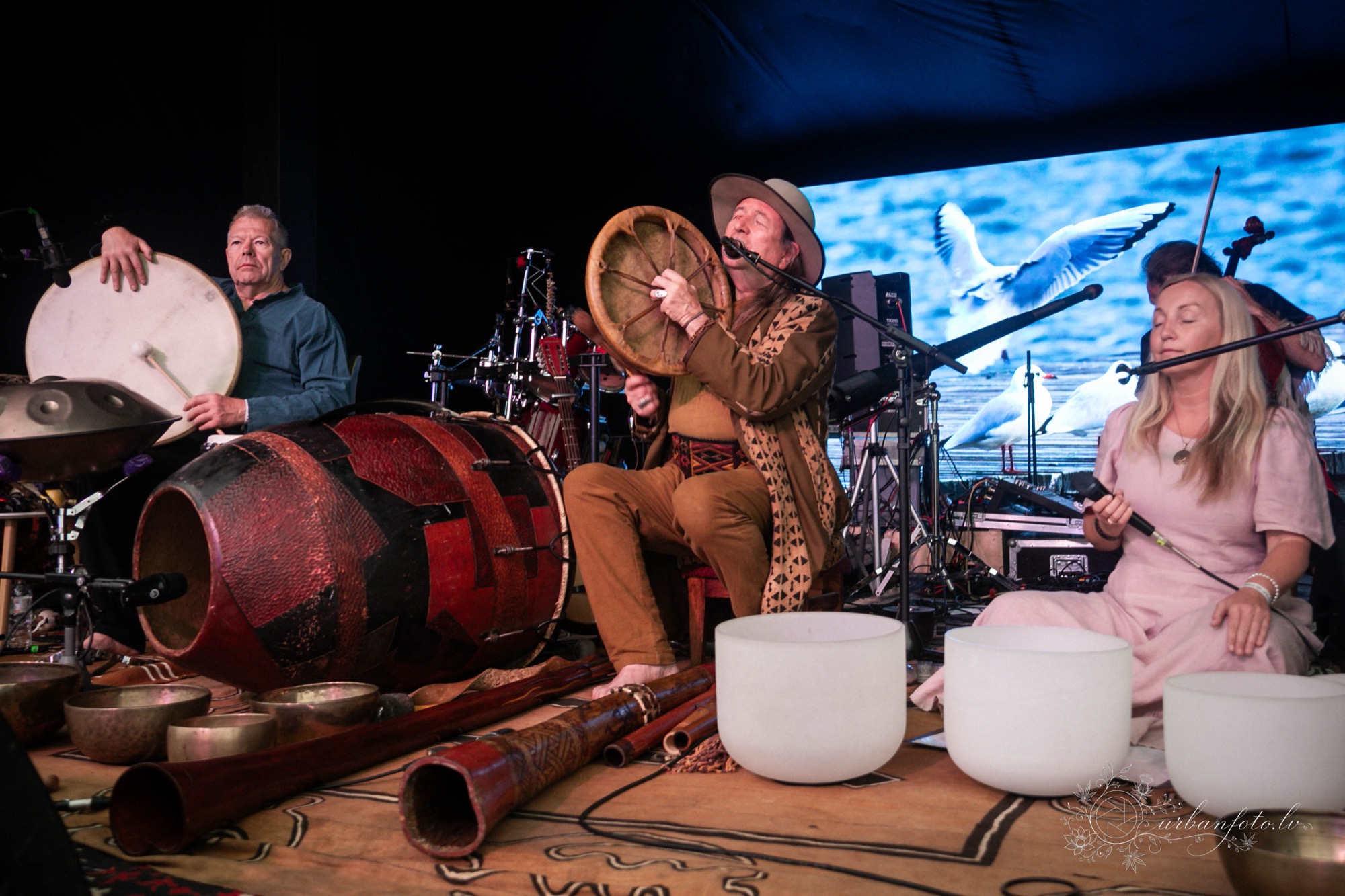 Musicians performing a live world music set with traditional drums, percussion and singing bowls at BŪTĪBA Festival 2026