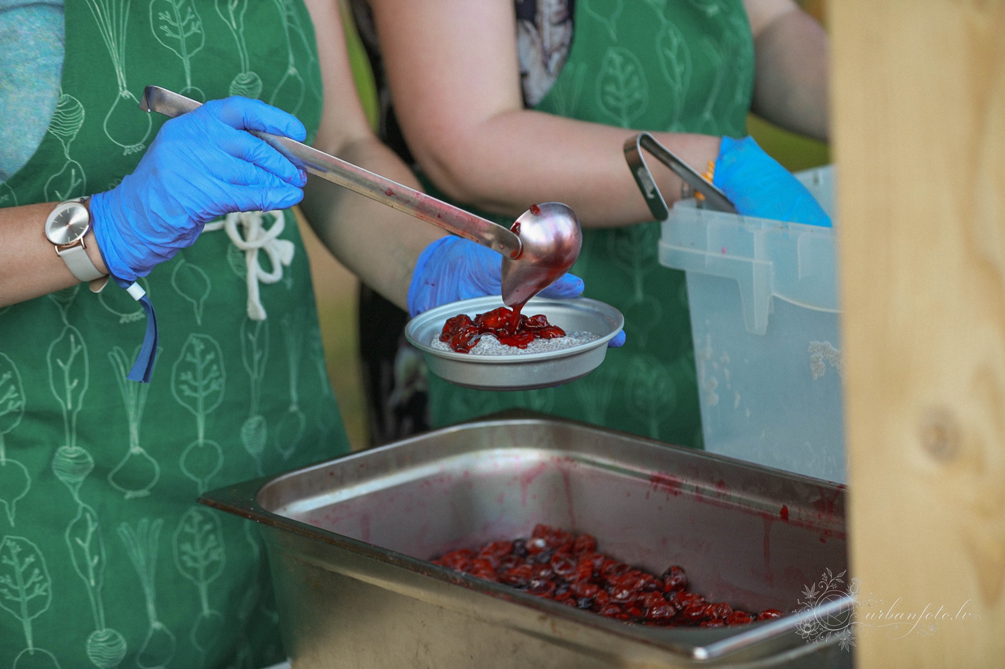 Festival food team serving a portion of freshly prepared food at BŪTĪBA Festival 2026