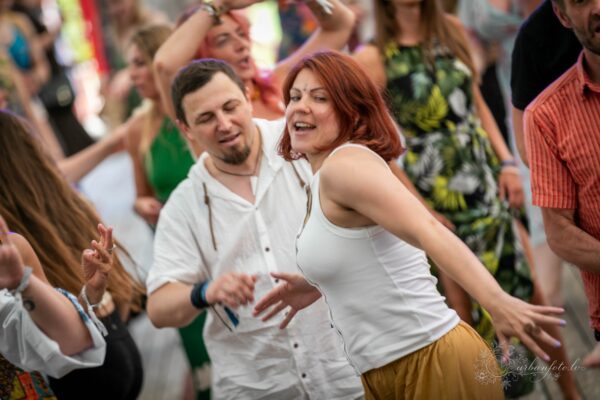 Festivāla apmeklētāji dejo un izbauda mūziku BŪTĪBA festivālā 2026 vasaras saulgriežu svinībās.