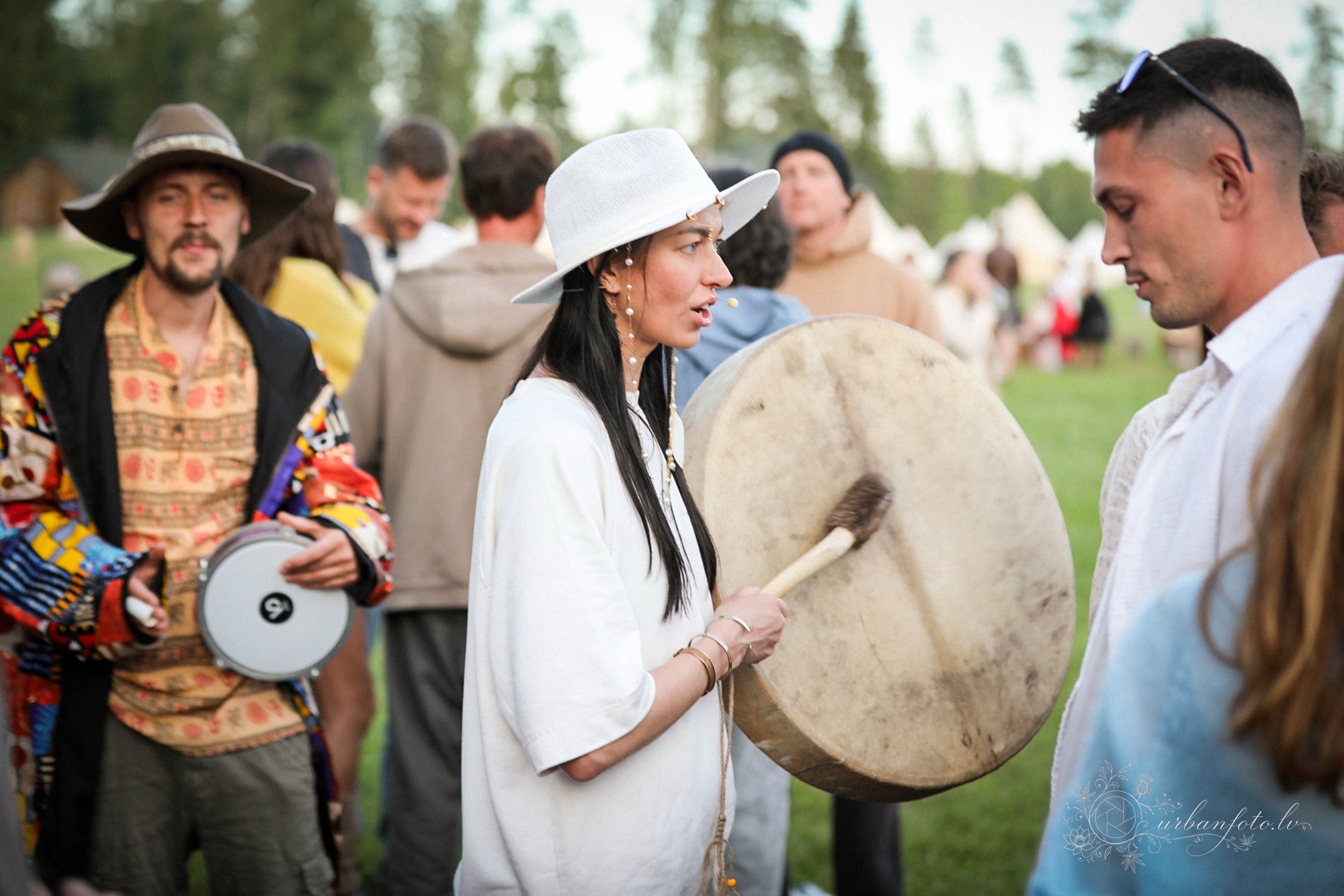 Festival participants playing large frame drums together during a community gathering at BŪTĪBA Festival 2026